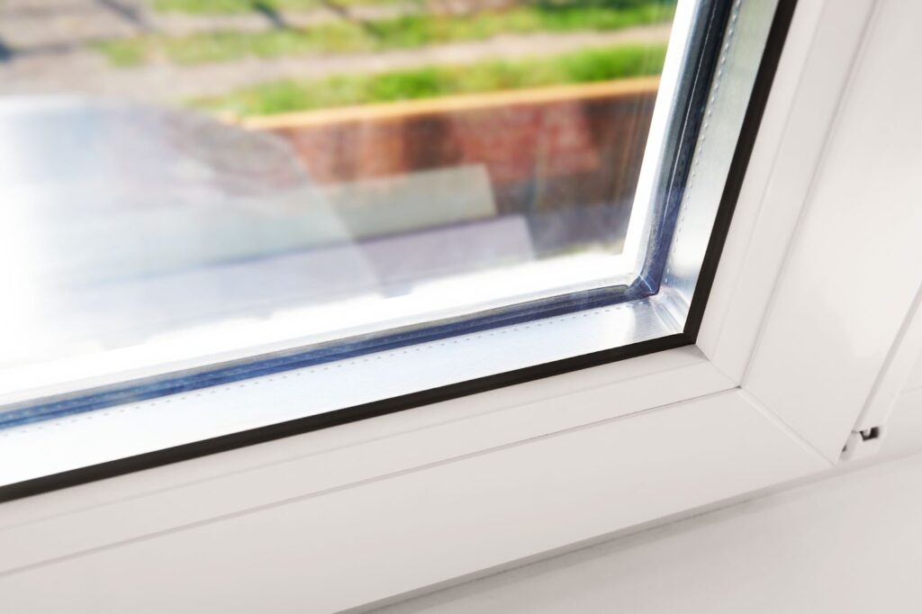 A white-framed window with a window sill, showcasing eco-friendly, energy-efficient glass