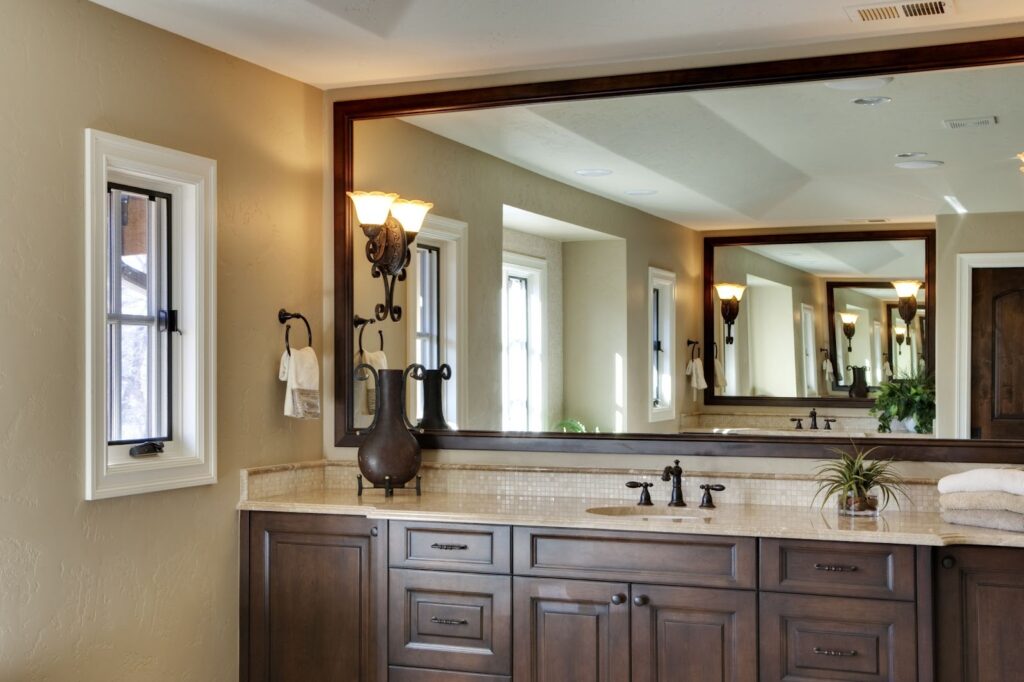 A bathroom with custom mirrors and a double sink