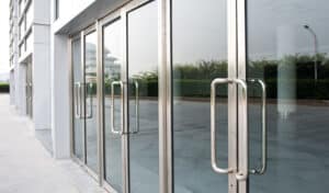 A Commercial Glass Door With Two Handles, Installed By Professional Commercial Glass Door Installers